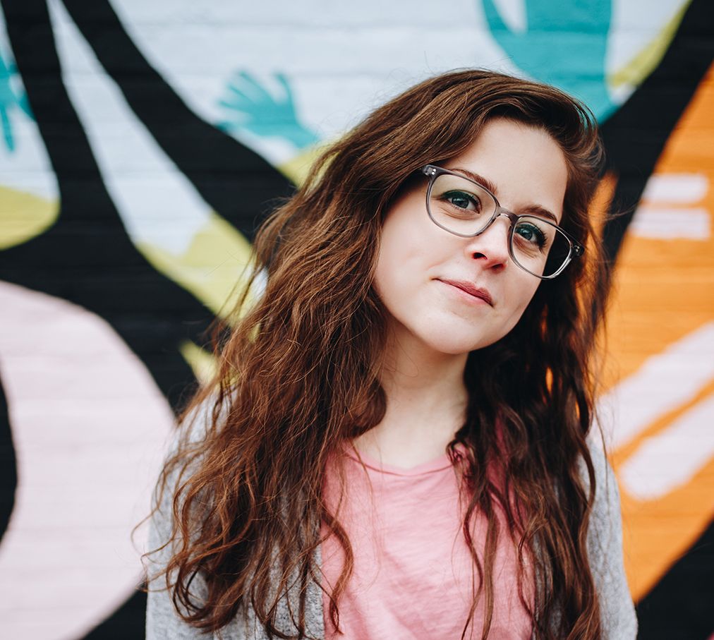 about-1 young woman with glasses looking at the camera